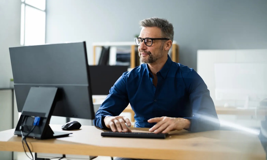 men working on computer database